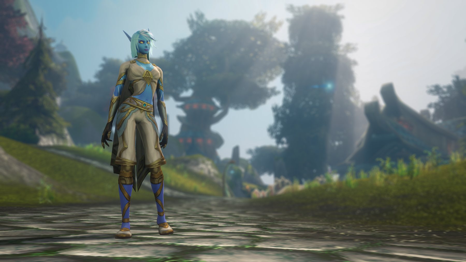 A Skyborne character with pale blue skin, white hair and glowing eyes standing on a stone road in Zephras Isle, with tiered wooden architecture in the mist behind.